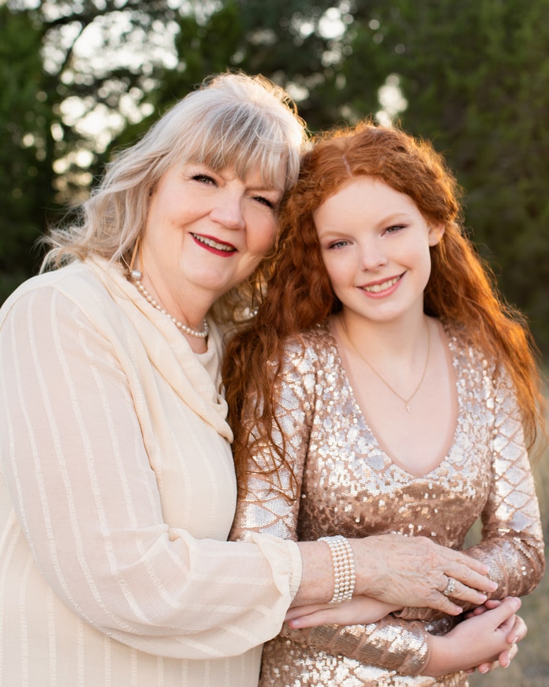 Family Photographer, grandmother holds daughter close, both all dressed up