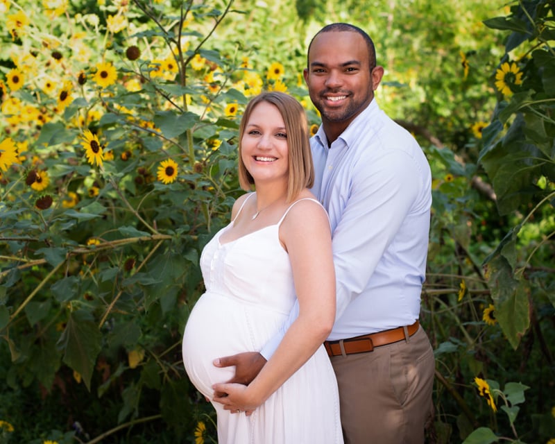 Maternity Photographer, Husband holds wife belly from behind her, they are expecting a baby soon