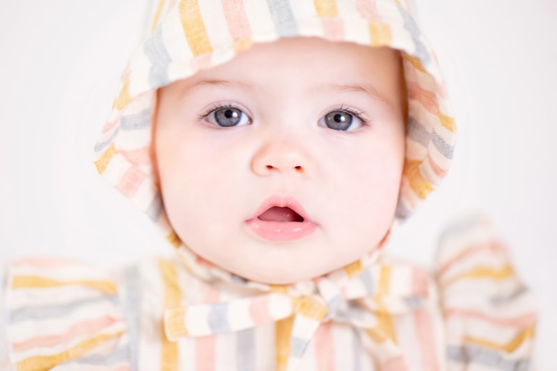 milestone photography, baby wears a dress with a striped hoody