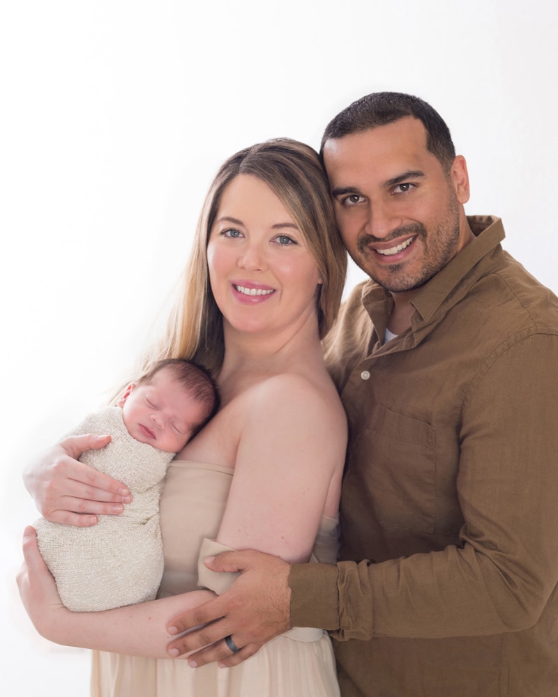 Newborn Photography,  mom and dad hold each other close, mom holds their new baby