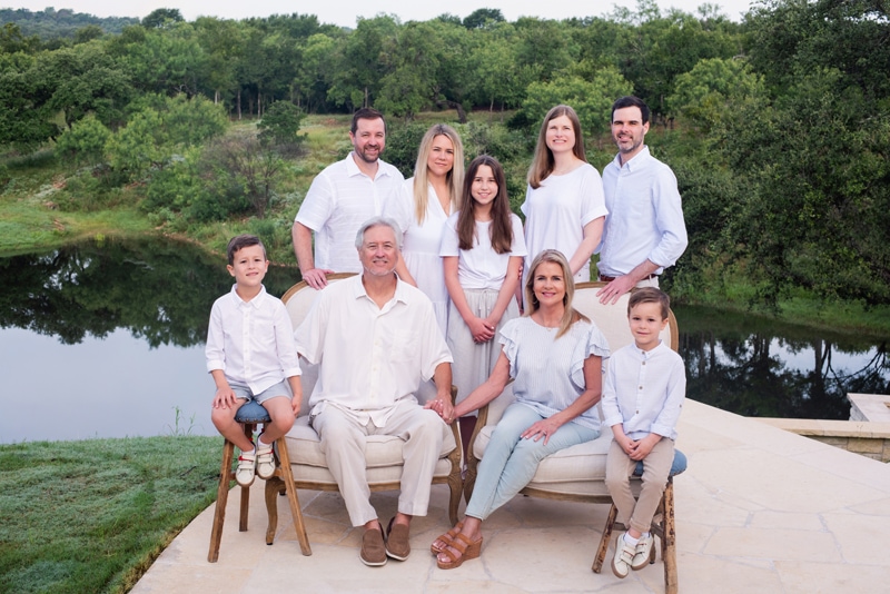 Family Photographer, entire family, including grandparents sit before a lake and forest